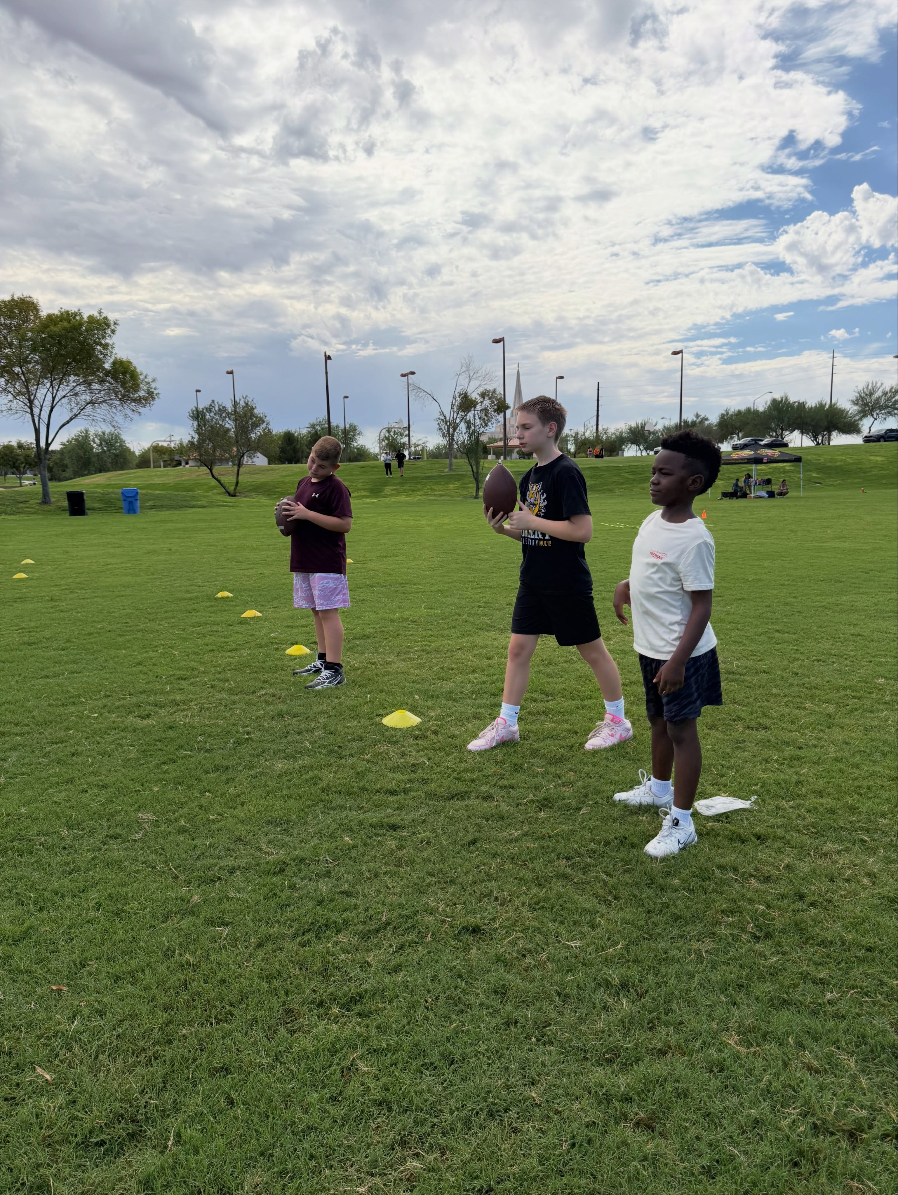 Athletes practise with footballs during a Little Legends session.